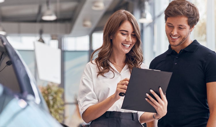 Salesperson showing the clipboard to a customer