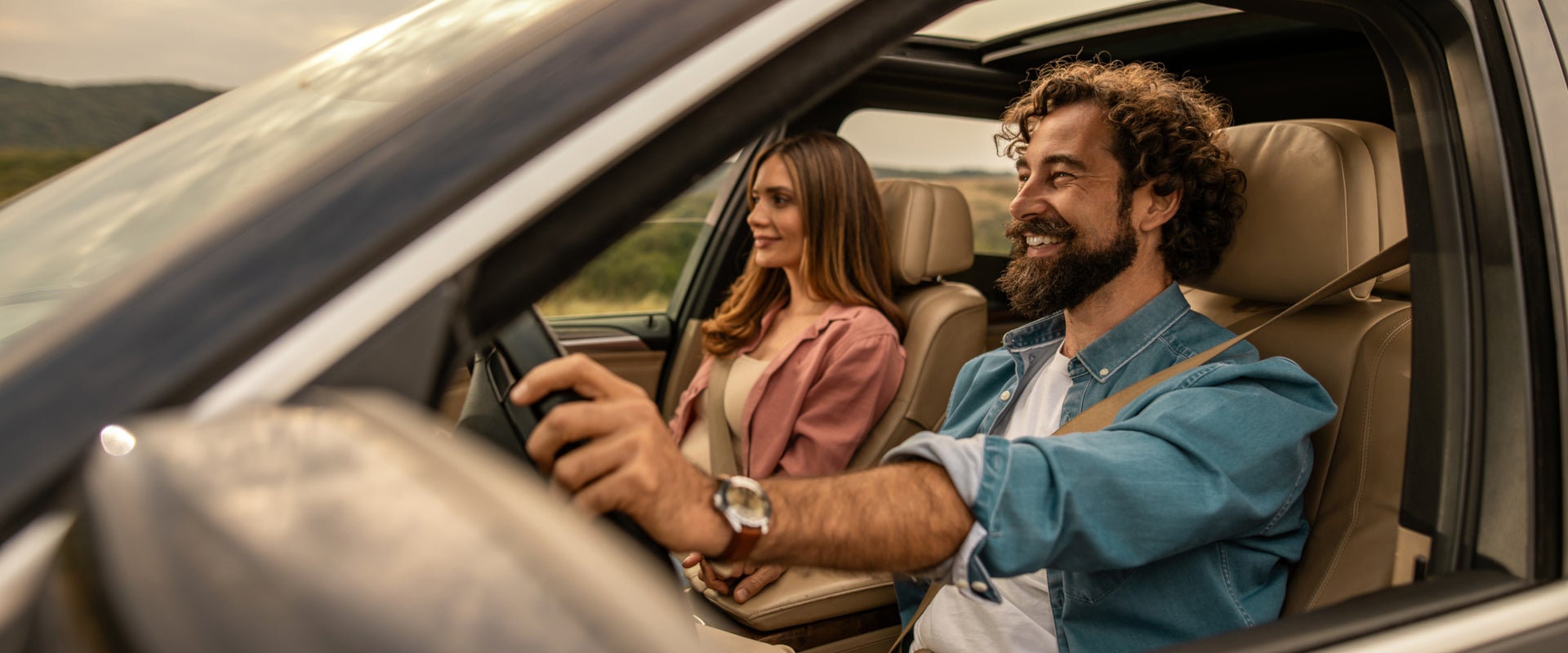 Couple driving off in their new car